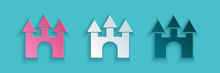 Paper cut Castle icon isolated on blue background. Paper art style. Vector