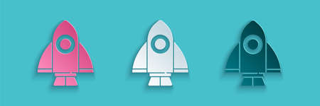 Paper cut Rocket ship icon isolated on blue background. Space travel. Paper art style. Vectorのイラスト素材