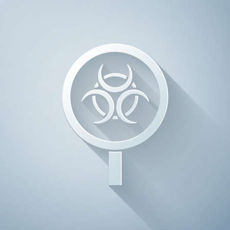 Paper cut Biohazard and magnifying glass icon isolated on grey background. Paper art style. Vectorのイラスト素材
