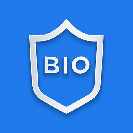 Paper cut Shield for bio green healthy food icon isolated on blue background. Organic product. Healthy food sticker. Paper art style. Vectorのイラスト素材