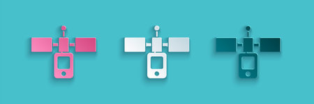 Paper cut Satellite icon isolated on blue background. Paper art style. Vector