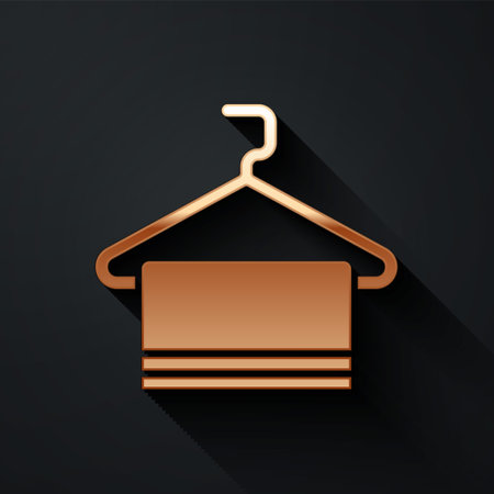 Gold Towel on hanger icon isolated on black background. Bathroom towel icon. Long shadow style. Vectorのイラスト素材