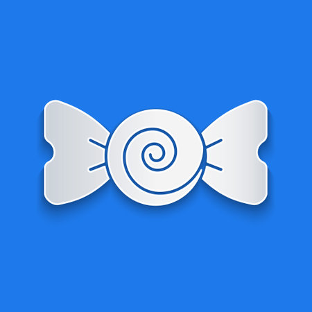 Paper cut Candy icon isolated on blue background. Merry Christmas and Happy New Year. Paper art style. Vectorのイラスト素材