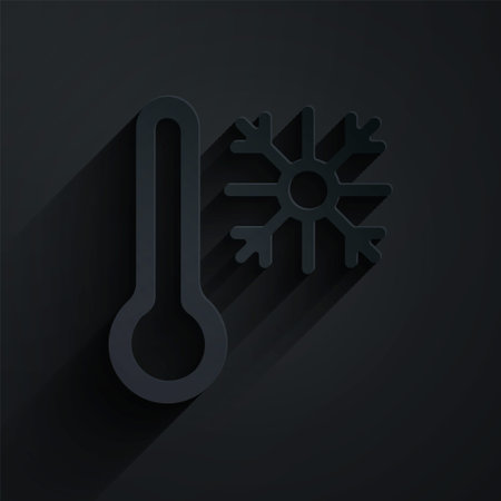 Paper cut Thermometer with snowflake icon isolated on black background. Paper art style. Vectorのイラスト素材