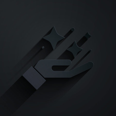 Paper cut Sparkle stars with magic trick icon isolated on black background. Magic christmas decoration. Paper art style. Vectorのイラスト素材