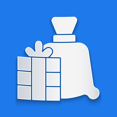 Paper cut Santa Claus bag gift icon isolated on blue background. Christmas presents sack. Merry Christmas and Happy New Year. Paper art style. Vectorのイラスト素材