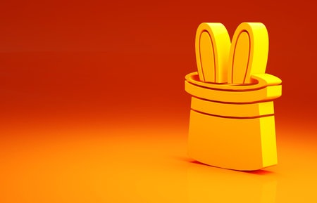 Yellow Magician hat and rabbit ears icon isolated on orange background. Magic trick. Mystery entertainment concept. Minimalism concept. 3d illustration 3D renderの写真素材