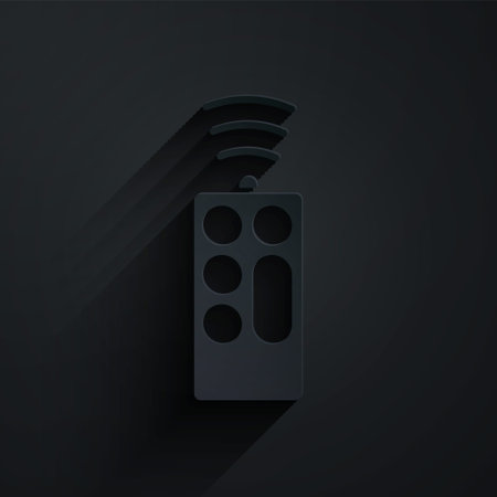 Paper cut Remote control icon isolated on black background. Paper art style. Vectorのイラスト素材