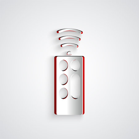 Paper cut Remote control icon isolated on grey background. Paper art style. Vectorのイラスト素材