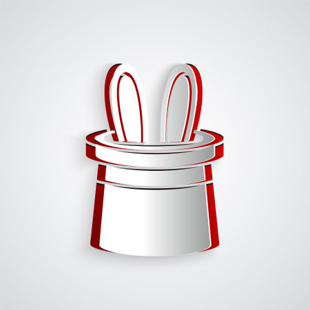 Paper cut Magician hat and rabbit ears icon isolated on grey background. Magic trick. Mystery entertainment concept. Paper art style. Vectorのイラスト素材