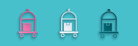 Paper cut Hotel luggage cart with suitcase icon isolated on blue background. Traveling baggage sign. Travel luggage icon. Paper art style. Vectorのイラスト素材