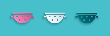 Paper cut Kitchen colander icon isolated on blue background. Cooking utensil. Cutlery sign. Paper...