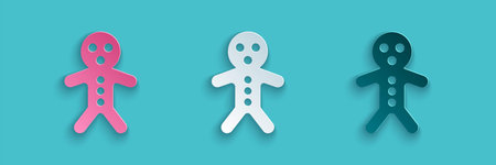 Paper cut Holiday gingerbread man cookie icon isolated on blue background. Cookie in shape of man...