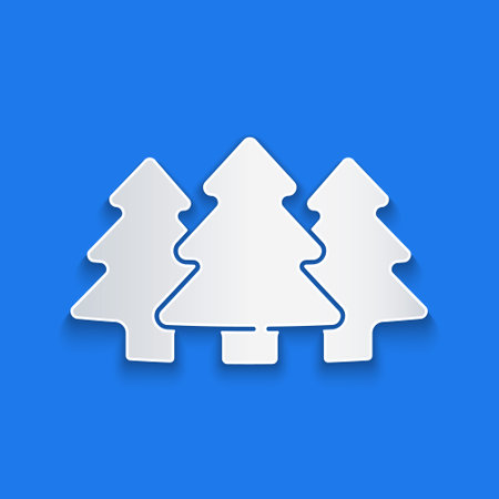 Paper cut Trees icon isolated on blue background. Forest symbol. Paper art style. Vectorのイラスト素材