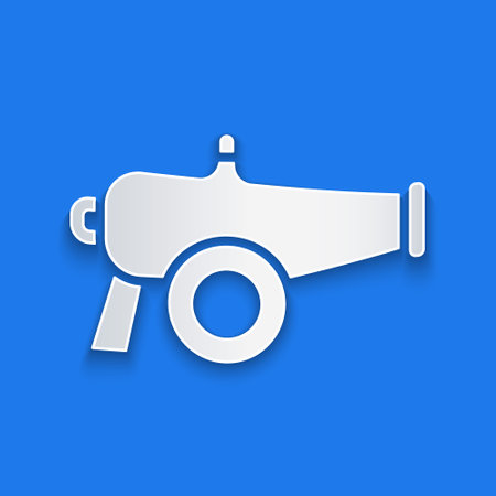 Paper cut Cannon icon isolated on blue background. Paper art style. Vectorのイラスト素材