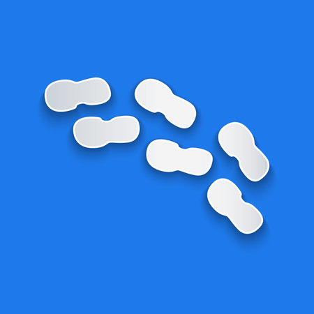 Paper cut Human footprints shoes icon isolated on blue background. Shoes sole. Paper art style....