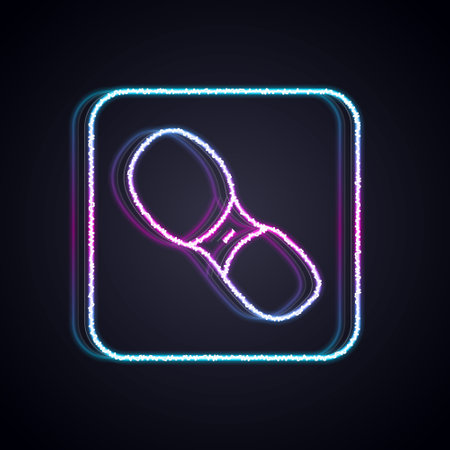 Glowing neon line Human footprints shoes icon isolated on black background. Shoes sole. Vectorのイラスト素材
