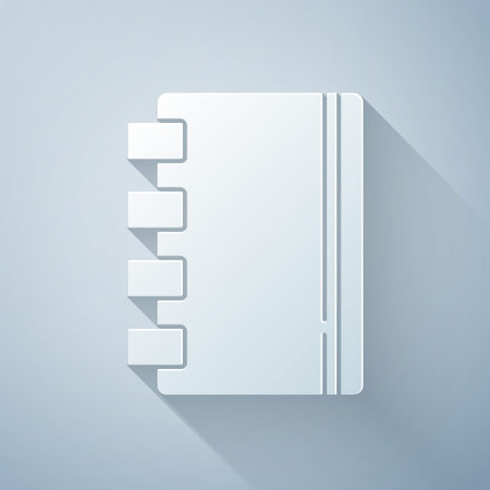Paper cut Notebook icon isolated on grey background. Spiral notepad icon. School notebook. Writing pad. Diary for school. Paper art style. Vectorのイラスト素材