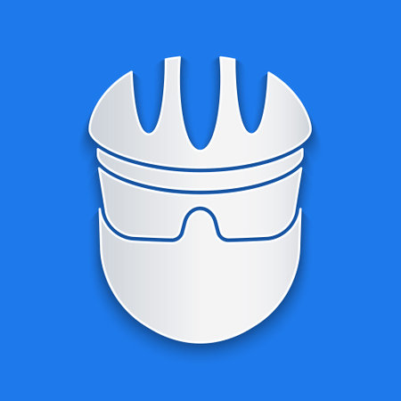 Paper cut Bicycle helmet icon isolated on blue background. Extreme sport. Sport equipment. Paper art style. Vectorのイラスト素材