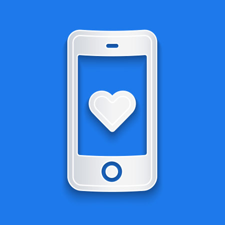 Paper cut Smartphone with heart emoji speech bubble get message on screen icon isolated on blue background. Valentines day. Paper art style. Vectorのイラスト素材