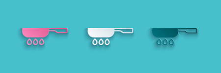 Paper cut Frying pan icon isolated on blue background. Fry or roast food symbol. Paper art style....