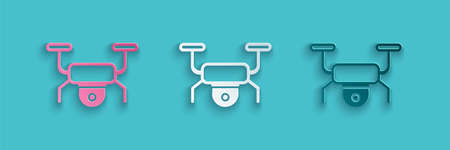 Paper cut Drone flying icon isolated on blue background. Quadrocopter with video and photo camera symbol. Paper art style. Vectorのイラスト素材