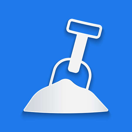 Paper cut Sandbox with sand and shovel icon isolated on blue background. Paper art style. Vectorのイラスト素材