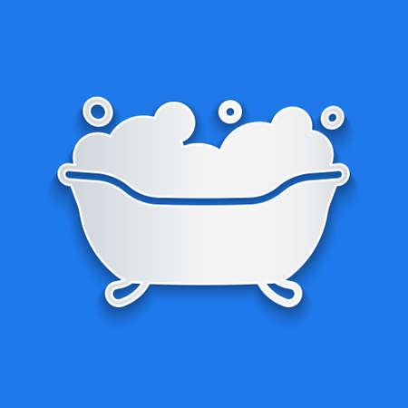 Paper cut Bathtub with foam bubbles inside icon isolated on blue background. Paper art style. Vectorのイラスト素材