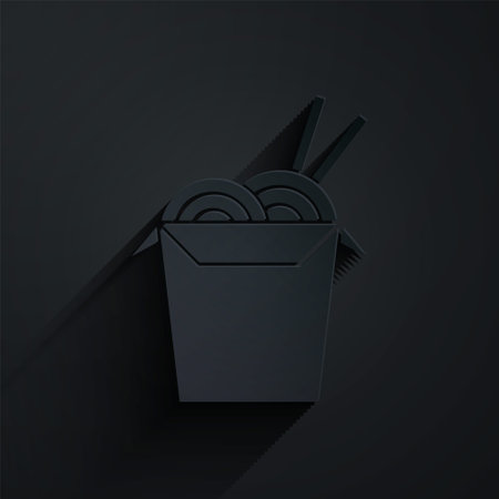 Paper cut Asian noodles in paper box and chopsticks icon isolated on black background. Street fast food. Korean, Japanese, Chinese food. Paper art style. Vector Illustrationのイラスト素材