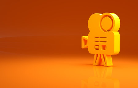 Yellow Retro cinema camera icon isolated on orange background. Video camera. Movie sign. Film projector. Minimalism concept. 3d illustration 3D renderの写真素材