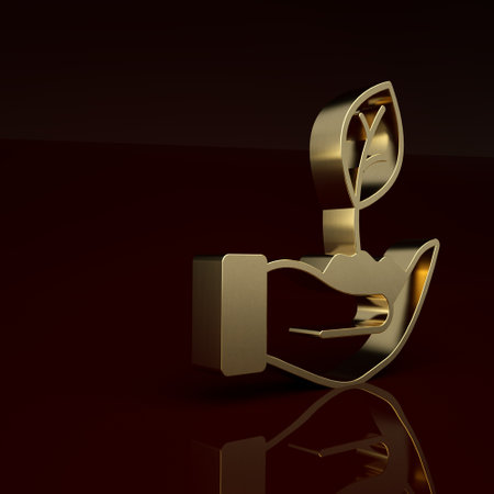 Gold Plant in hand of environmental protection icon isolated on brown background. Seed and seedling. Planting sapling. Minimalism concept. 3D render illustrationの写真素材