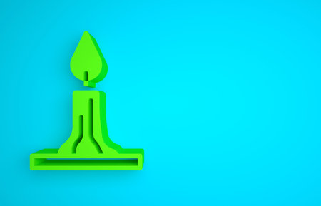 Green Burning candle in candlestick icon isolated on blue background. Cylindrical candle stick with burning flame. Minimalism concept. 3D render illustrationの写真素材