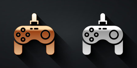 Gold and silver Gamepad icon isolated on black background. Game controller. Long shadow style. Vectorのイラスト素材