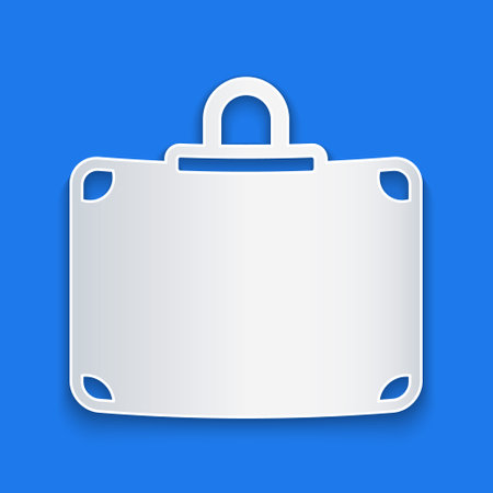 Paper cut Suitcase for travel icon isolated on blue background. Traveling baggage sign. Travel luggage icon. Paper art style. Vectorのイラスト素材