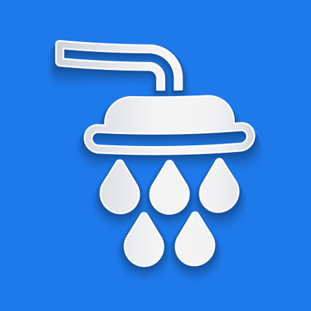 Paper cut Shower head with water drops flowing icon isolated on blue background. Paper art style. Vectorのイラスト素材