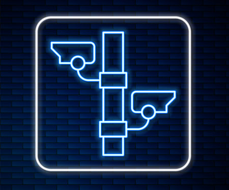 Glowing neon line Security camera icon isolated on brick wall background. Vectorのイラスト素材