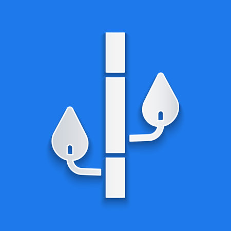 Paper cut Bamboo icon isolated on blue background. Paper art style. Vectorのイラスト素材