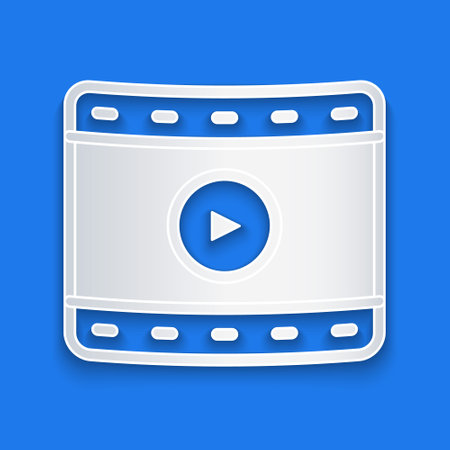 Paper cut Play Video icon isolated on blue background. Film strip sign. Paper art style. Vector.のイラスト素材