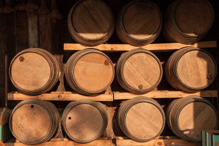 Wooden barrel stack in shelf with sunset shine on.