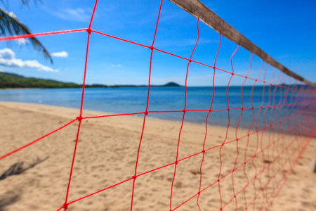 Volleyball net on beach and blue sea.の写真素材