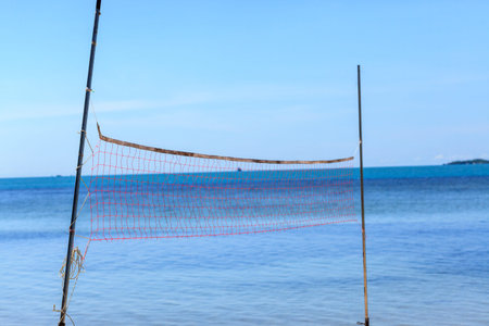 Volleyball net on beach and blue sea.の写真素材