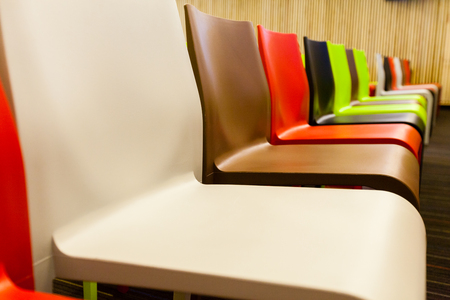Colorful chairs arranged in a meeting room.の写真素材