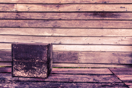 Background of wooden panel stacking together with square box on floor.の写真素材