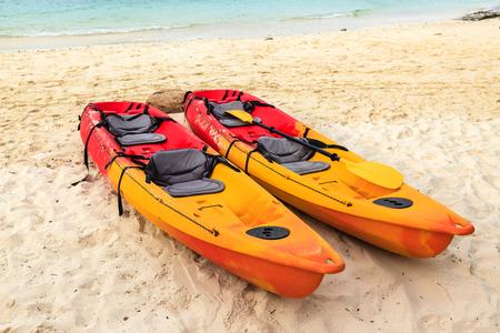Two colorful empty canoe on the beach.の写真素材