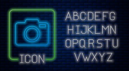 Glowing neon Photo camera icon isolated on brick wall background. Foto camera icon. Neon light alphabet. Vector Illustrationのイラスト素材