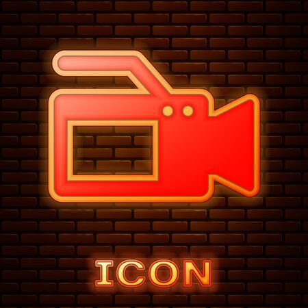 Glowing neon Cinema camera icon isolated on brick wall background. Video camera. Movie sign. Film projector. Vector Illustrationのイラスト素材