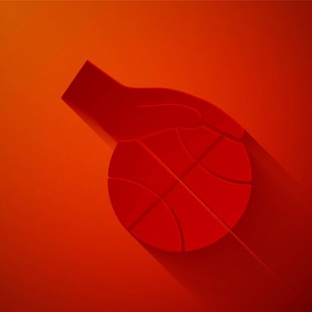 Paper cut Hand with basketball ball icon isolated on red background. Sport symbol. Paper art style. Vector Illustrationのイラスト素材