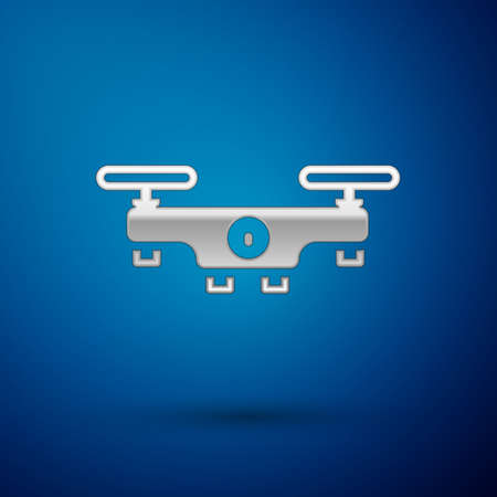 Silver Drone flying icon isolated on blue background. Quadrocopter with video and photo camera symbol. Vectorのイラスト素材