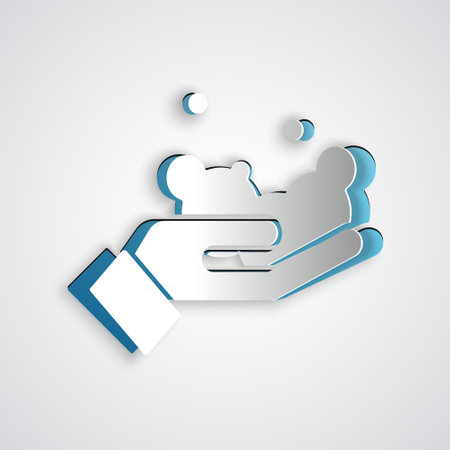 Paper cut Washing hands with soap icon isolated on grey background. Washing hands with soap to prevent virus and bacteria. Paper art style. Vector.のイラスト素材