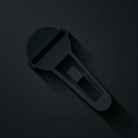 Paper cut Microphone icon isolated on black background. On air radio mic microphone. Speaker sign. Paper art style. Vectorのイラスト素材